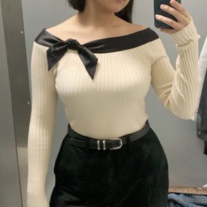 off the shoulder cream sweater w/ black silk trim